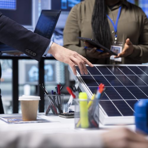 Investors meeting with photovoltaics factory experts to review solar cell designs. Solar panels plant shareholders discussing technical specifications, analyzing sustainable energy solutions, close up